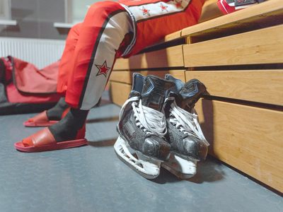Le vestiaire : les casiers, les maillots aux patères, le banc.
